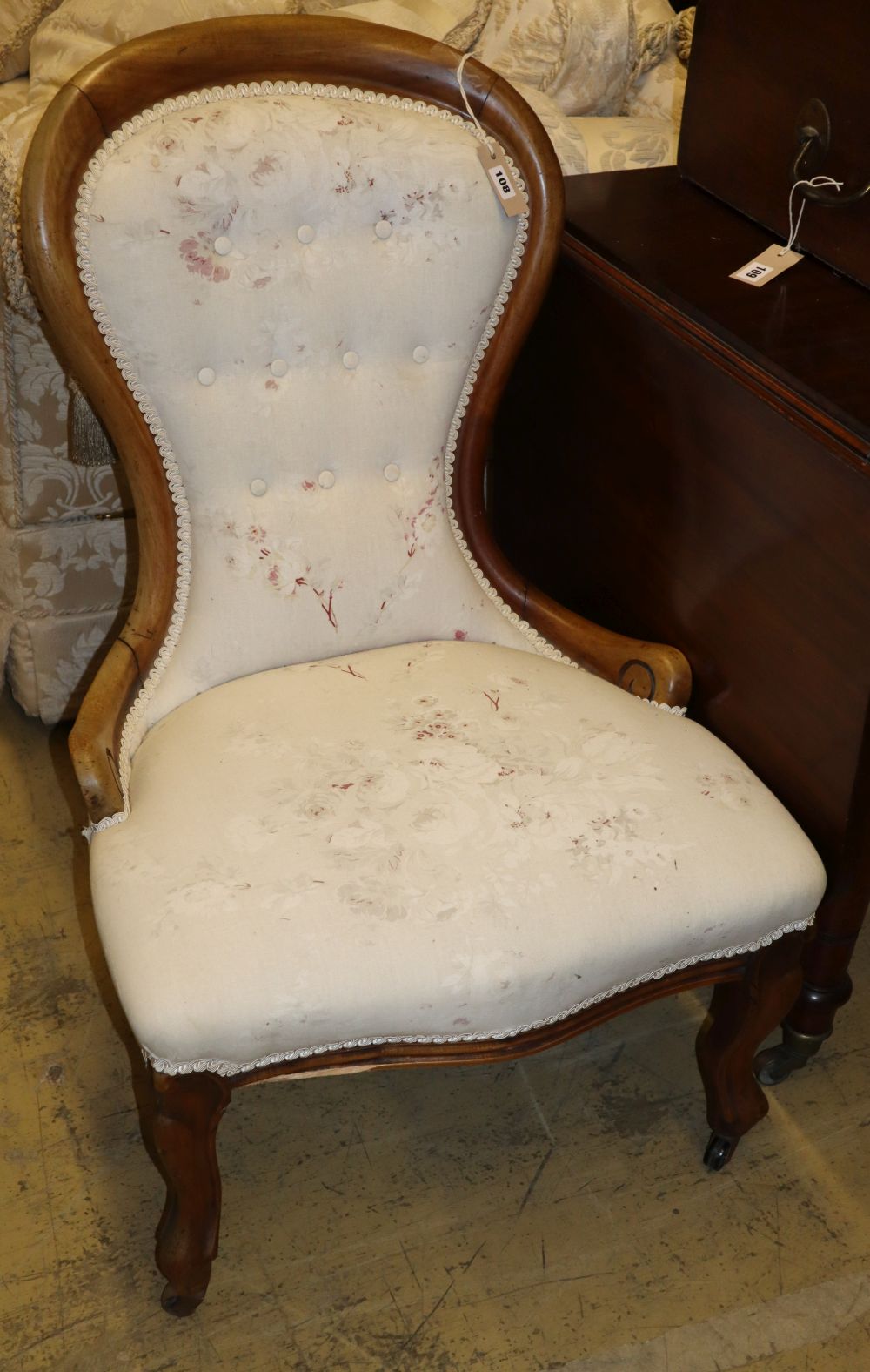 A Victorian faded mahogany spoon back nursing chair